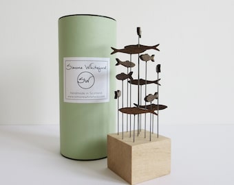 Walnut coloured shoal of fish in a decorative tube, small sculpture for windowsill, desk, bookshelf