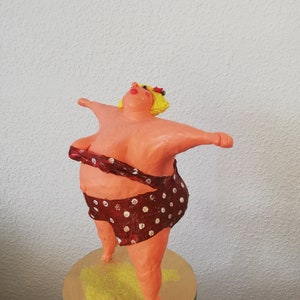 Paper mache figure of a confident woman, swimmer Paper mache figure