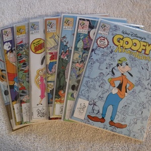 May include: A stack of eight comic books featuring Goofy, a cartoon dog character from Disney. The top comic book is titled "Walt Disney's Goofy Adventures".