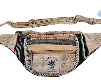 May include: A beige hemp fanny pack with multiple zippered compartments and an adjustable strap. The pack features a colorful striped design on the sides and the text "HIMALAYAN HEMP THC FREE MADE IN NEPAL".