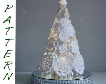 May include: A white crocheted Christmas tree with a sparkly silver base. The tree is decorated with white flowers and lights.