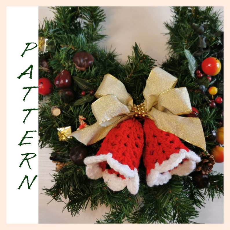May include: A red and white crocheted Christmas bell ornament with a gold bow on a green wreath.