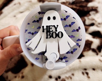 May include: White ghost-shaped lid with a black "Hey Boo" text and a bat pattern. The lid is designed for a tumbler or cup.