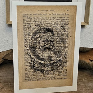 Weihnachts Falt Karte aus Struktur Leinen Papier, mit Weihnachtsmann Kopf und Merry Christmas, auf Antiker Buchseite, Santa Claus, Xmas