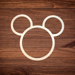 May include: A wooden cutout of a Mickey Mouse head with three circles. The circles are all connected and form the shape of a head with two large ears.