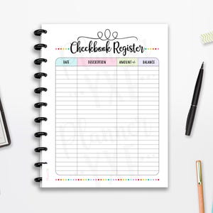 May include: A white checkbook register with a black spiral binding, featuring a colorful border and the title "Checkbook Register." A black pen, colorful pens, washi tape, and a checkbook are also visible.