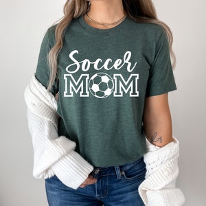 May include: A green t-shirt with the text "Soccer Mom" in white with a white soccer ball graphic.