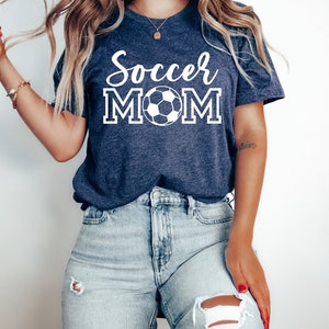 May include: A navy blue t-shirt with the text "Soccer Mom" in white with a white soccer ball graphic.