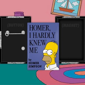 May include: A blue and white square button with the text "HOMER, I HARDLY KNEW ME" and a yellow cartoon character with a white shirt. The text "by HOMER SIMPSON" is below the cartoon character.