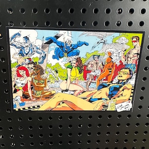 May include: A comic book illustration of a group of superheroes relaxing by a pool. The characters are wearing swimsuits and enjoying the summer weather. The text "Wish you were here!" is written on a small sign in the bottom right corner of the image.