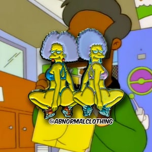 May include: Two yellow cartoon characters with blue and purple swimsuits and gray hair, in a squatting pose. The characters are wearing orange and blue shoes. The image includes the text "@ABNORMALCLOTHING".