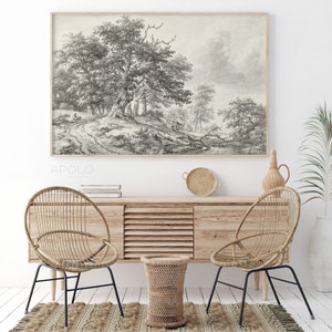 May include: A black and white sketch of a woodland scene with trees and a path. The sketch is framed and hanging on a white wall above a wooden cabinet with two wicker chairs and a small wicker stool.