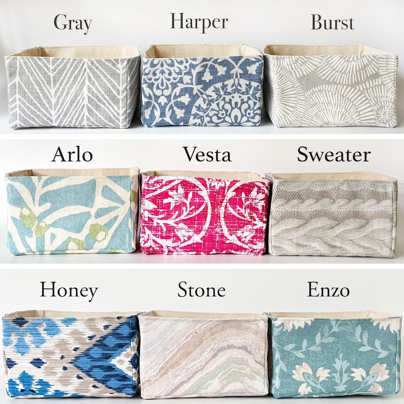 May include: Nine fabric storage bins in various patterns and colors. The bins are labeled with names like "Gray", "Harper", "Burst", "Arlo", "Vesta", "Sweater", "Honey", "Stone", and "Enzo". Each bin has a neutral-colored interior.