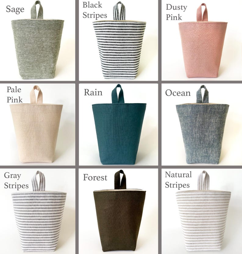 May include: Nine fabric storage bins in various colors and patterns. Colors include sage, black stripes, dusty pink, pale pink, rain, ocean, gray stripes, forest, and natural stripes. Each bin has a matching handle.
