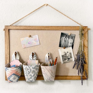 May include: A rustic wooden sign with the text "Welcome to our home" in white lettering. The sign has a distressed finish and a simple, inviting design, suitable for a front porch or entryway.