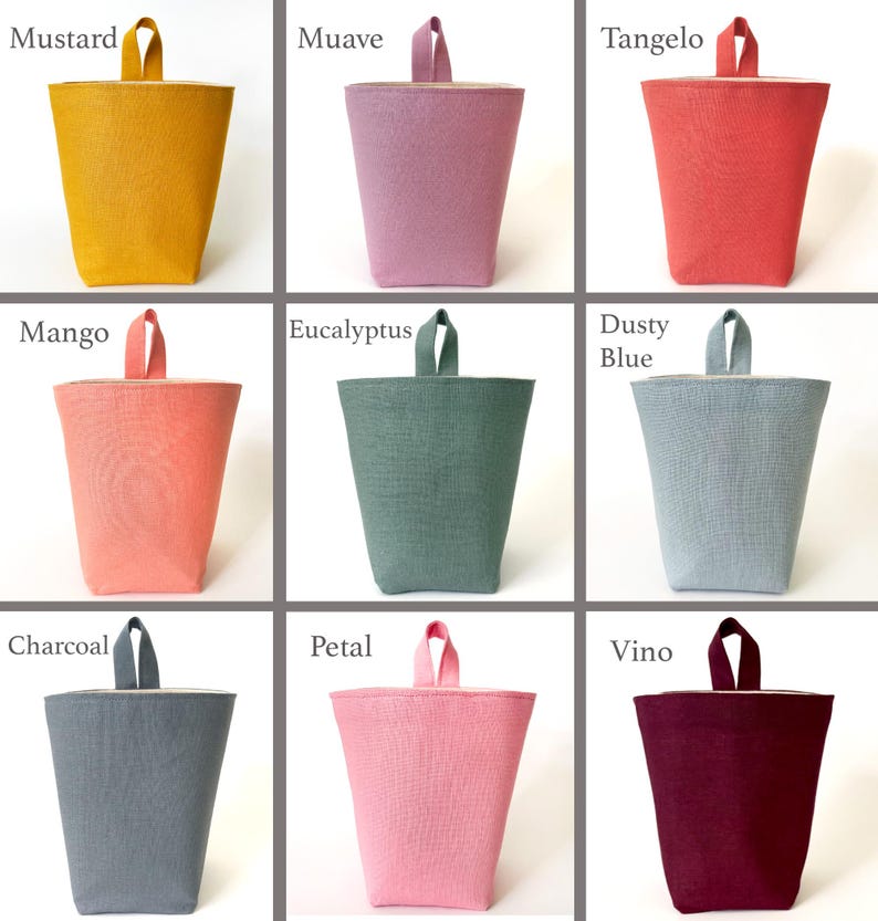 May include: A collection of fabric storage bins in various colors, including mustard, mauve, tangelo, mango, eucalyptus, dusty blue, charcoal, petal, and vino. Each bin has a handle and a contrasting interior.