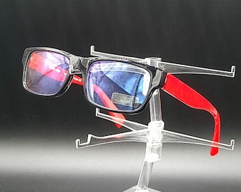 May include: Black framed glasses with red arms. The lenses are blue tinted.
