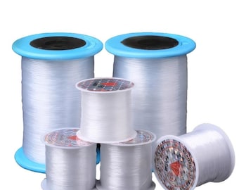 May include: Five spools of clear fishing line, with blue and white labels. The labels say "Strong & stretchy" and "Super Strong".