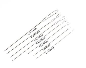 May include: Set of six silver-colored beading needles with loops at the ends. The needles are labeled with their diameter and length in millimeters: 0.7x130mm, 0.6x130mm, 0.5x130mm, 0.4x130mm, 0.3x100mm, 0.2x80mm, and 0.15x80mm.