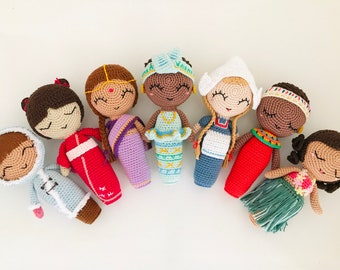 May include: A set of eight crocheted dolls representing different cultures. Each doll is wearing traditional clothing and has a unique hairstyle. The dolls are all smiling and have closed eyes.