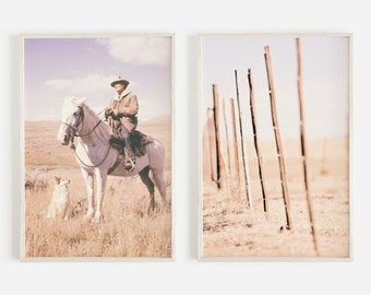 May include: Two framed prints with a vintage aesthetic. One shows a cowboy on a white horse with a dog in a field. The second print depicts a weathered fence in a field, both with a sepia tone.