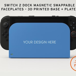 May include: A black Switch 2 dock with a blue faceplate that reads "YOUR DESIGN HERE." The dock has magnetic swappable faceplates and a 3D printed base and plates. The image also includes the text ".3MF FILE."