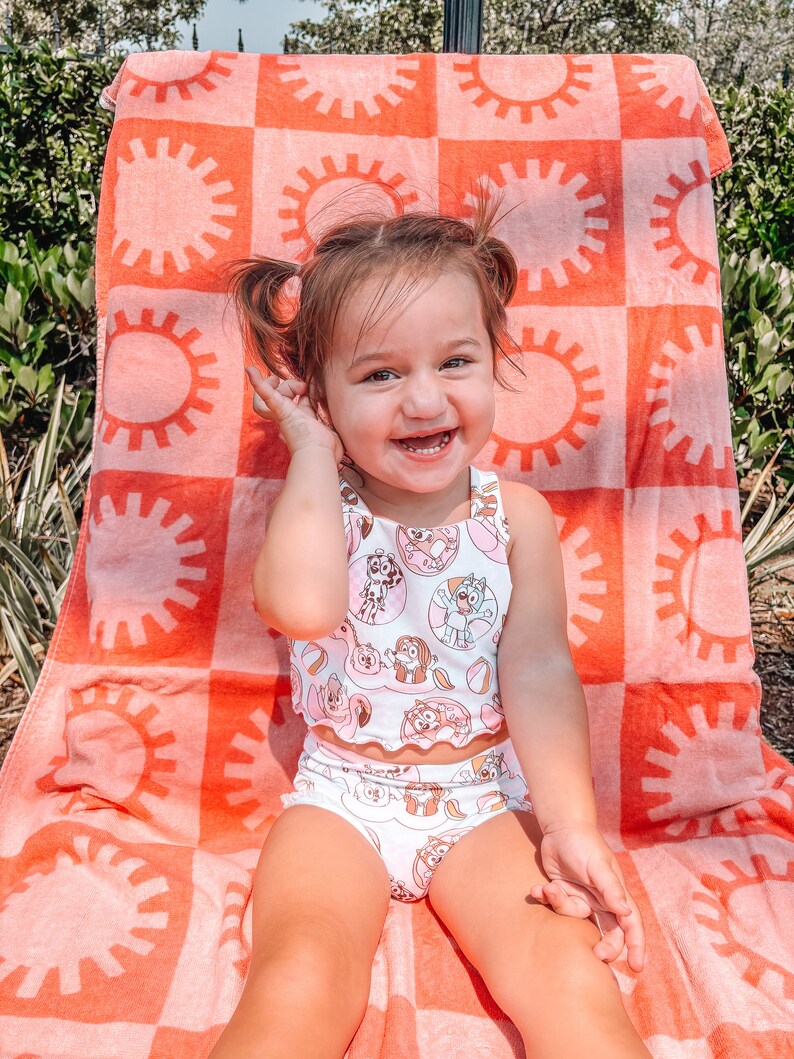 May include: A white ceramic mug with a black handle and the text "But First, Coffee" in a bold, black font. The mug is set against a blurred background, suggesting a cosy setting.
