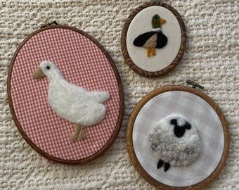 Felt heirloom animal in embroidery hoop