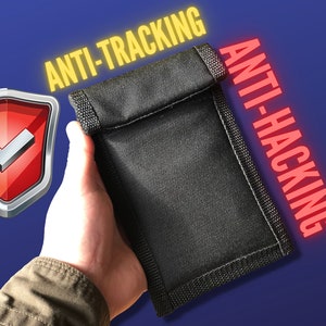 May include: A black fabric pouch with the text "ANTI-TRACKING" and "ANTI-HACKING" in yellow and red letters. A red shield with a white checkmark is in the background.