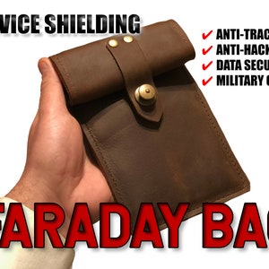 May include: A brown leather Faraday bag with a brass button closure. The bag is designed to block electronic signals and protect devices from tracking and hacking. The text "DEVICE SHIELDING" and "FARADAY BAG" is printed on the image. The text "ANTI-TRACKING", "ANTI-HACKING", "DATA SECURITY", and "MILITARY GRADE" is also printed on the image.
