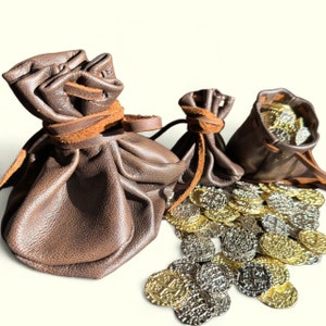 May include: Three brown leather pouches with drawstrings, filled with gold coins. The pouches are on a white background.