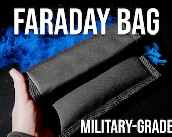 May include: Two black Faraday bags with the text "FARADAY BAG" and "MILITARY-GRADE" in white. The bags are rectangular and appear to be made of a durable, textured material. A hand is holding one of the bags, with a blue smoky effect in the background.