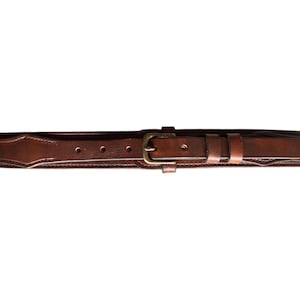 May include: A brown leather belt with a brass buckle. The belt has a decorative stitching pattern.