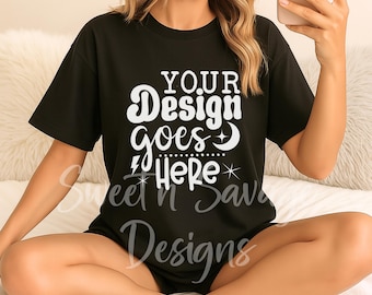 May include: Black t-shirt with the text "YOUR Design goes Here" in white script. The shirt is a short-sleeved style. The words "Sweet n Sav Designs" are also printed on the shirt in a cursive font.