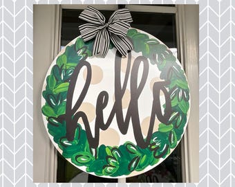 Colgador de puerta con texto "Hola" de Laurel Leaf