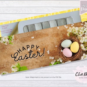 May include: A set of nail wraps with a glittery finish. The design features a wooden background with a nest of Easter eggs and white flowers. The text "Happy Easter!" is written in a cursive font.