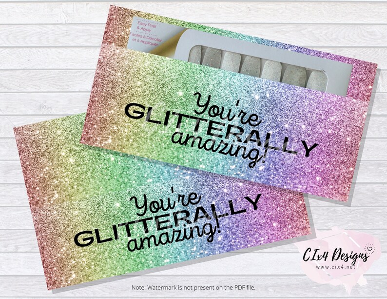 May include: Two rainbow glitter envelopes with the text "You're GLITTERALLY amazing!" printed on them. The envelopes are designed for nail polish strips.