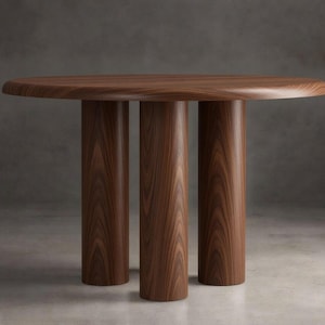 May include: A round dining table crafted from dark brown wood with a prominent grain pattern. The table features a smooth, circular tabletop supported by three thick, cylindrical legs that extend vertically from the base to the underside.