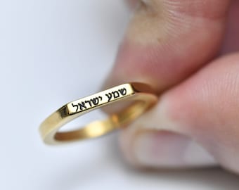 May include: A gold square ring with the Hebrew words "אהבה יפה" engraved on the band.