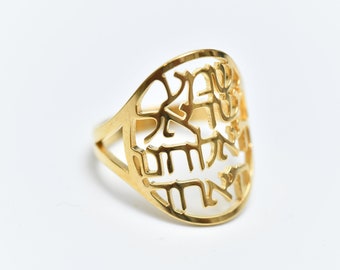 May include: A gold ring with a cutout design featuring Hebrew lettering.