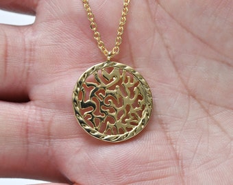 May include: Gold necklace with a round pendant featuring a delicate, intricate design of a tree with branches and leaves.