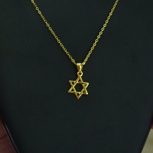 May include: A gold chain necklace with a Star of David pendant.