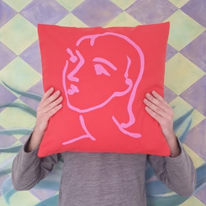 Matisse style Art Cushion Cover - drawing of Nadia printed in pink on a red canvas cotton cushion 45 x 45cm