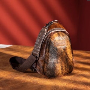 Wrangler Sling Bag/Crossbody/Chest Bag-Hair On Leather Coffee Sling Bag w/Top Zipper Closure & Adjustable Strap