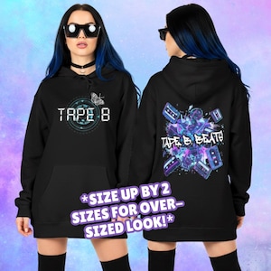 May include: Black hoodie with "TAPE 8" on the front and a butterfly graphic. The back displays "TAPE B. BEATS" with purple and blue cassette tape graphics. The text "*SIZE UP BY 2 SIZES FOR OVER-SIZED LOOK!*" is also visible.