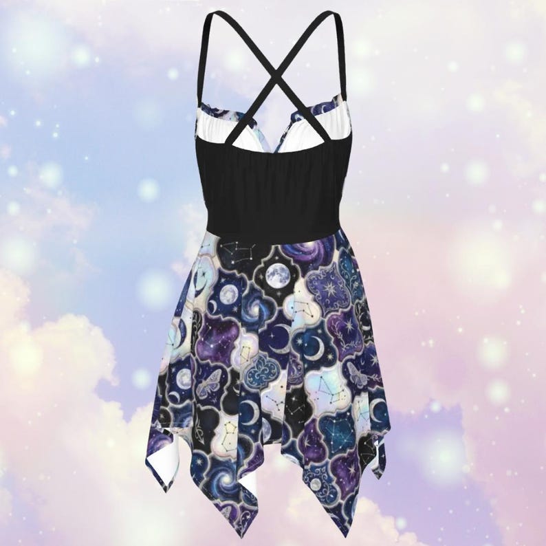 May include: A black and white dress with a celestial print. The dress features a black bodice with crisscross straps and a flared skirt adorned with moons, stars, and constellations in shades of blue, purple, and white.