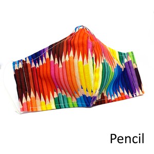 May include: A colorful face mask with a pattern of many colored pencils. The mask is made of fabric and has a white elastic band.