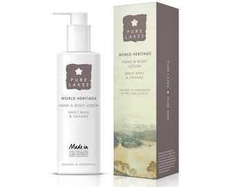 May include: A white bottle of hand and body lotion with a brown label that says "Pure Lakes World Heritage Hand & Body Lotion Sweet Basil & Orange" and "Made in The English Lake District World Heritage Site Natural & Handmade". The bottle is next to a brown box with the same label.
