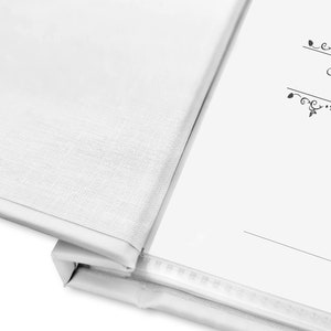 May include: White blank book with a black decorative border and the text "Stammbuch Familie" on the cover.