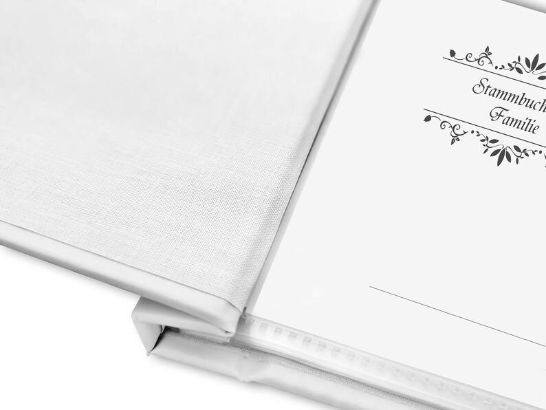 May include: White blank book with a black decorative border and the text "Stammbuch Familie" on the cover.